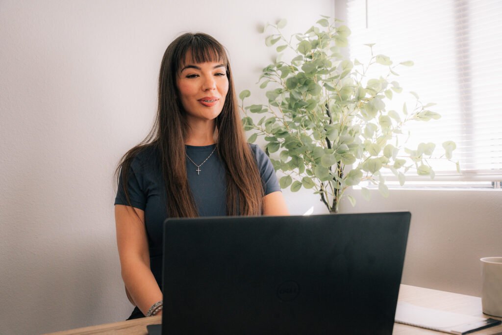 Woman using a laptop at home for online therapy